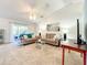 Comfortable living room with plush carpeting, vaulted ceilings, and sliding glass doors to the outside at 1407 Island Cove Dr, Deland, FL 32724