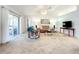 Comfortable living room with plush carpeting, vaulted ceilings, and sliding glass doors to the outside at 1407 Island Cove Dr, Deland, FL 32724