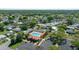 An aerial view of the community's pool and surrounding homes and golf course in the distance at 1541 Doral Cir, Lady Lake, FL 32159