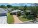 Residential home with manicured lawn, surrounded by mature trees at 1541 Doral Cir, Lady Lake, FL 32159