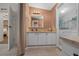 Bathroom with neutral walls, step in shower, washer and dryer access at 1541 Doral Cir, Lady Lake, FL 32159