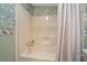 Cozy bathroom with shower and tub combo, plus patterned wallpaper at 1541 Doral Cir, Lady Lake, FL 32159