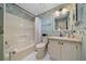 Charming bathroom with patterned wallpaper and a shower-tub combo at 1541 Doral Cir, Lady Lake, FL 32159