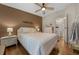 Cozy bedroom featuring warm wood floors and a decorative accent wall at 1541 Doral Cir, Lady Lake, FL 32159