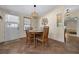 Cozy dining area featuring modern lighting, wall decor and exterior door at 1541 Doral Cir, Lady Lake, FL 32159
