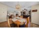 Dining room leading to kitchen featuring decorative chandelier, views of the open floor plan, and room for four at 1541 Doral Cir, Lady Lake, FL 32159