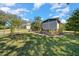 Well-maintained home with a landscaped yard and mature trees at 1541 Doral Cir, Lady Lake, FL 32159