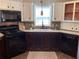 Charming kitchen features white cabinets, stainless appliances, and a cozy rug at 1541 Doral Cir, Lady Lake, FL 32159