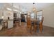 A well-lit kitchen with wood cabinets, eat-in nook, and modern light fixture at 1541 Doral Cir, Lady Lake, FL 32159