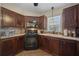 Well-equipped kitchen featuring dark wood cabinets, modern appliances, and backsplash at 1541 Doral Cir, Lady Lake, FL 32159