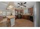 Spacious kitchen featuring modern appliances, dark wood cabinets, and open floor plan to the living room at 1541 Doral Cir, Lady Lake, FL 32159