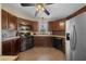 Spacious kitchen features modern appliances, wood cabinetry, and ample counter space for cooking at 1541 Doral Cir, Lady Lake, FL 32159