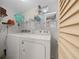 Convenient laundry room with washer, dryer, storage shelving, and a window at 1541 Doral Cir, Lady Lake, FL 32159