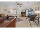 Bright living room with a ceiling fan, comfortable seating, and access to outdoor patio at 1541 Doral Cir, Lady Lake, FL 32159
