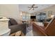 Comfortable living room with neutral colors, tile flooring, and a sliding glass door to the patio at 1541 Doral Cir, Lady Lake, FL 32159