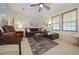 Comfortable living room with a plush sectional sofa, area rug, and natural light from the window at 1541 Doral Cir, Lady Lake, FL 32159