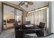 Relaxing screened patio with wicker furniture, ceiling fan, and view into the living room at 1541 Doral Cir, Lady Lake, FL 32159