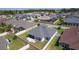 Aerial view of a home and its neighborhood featuring a backyard, lush landscaping, and privacy fence at 1589 Armstrong Ave, The Villages, FL 32163