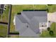 Overhead view of a well-maintained home with a manicured lawn, landscaping, and spacious backyard at 1589 Armstrong Ave, The Villages, FL 32163