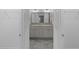 Bathroom featuring a double vanity, a large mirror, and tile flooring at 1589 Armstrong Ave, The Villages, FL 32163