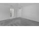 Bedroom featuring neutral carpet, a ceiling fan, and doorways leading to two bathrooms at 1589 Armstrong Ave, The Villages, FL 32163