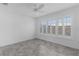 This bright bedroom offers tile flooring, a ceiling fan, and large windows with shutters at 1589 Armstrong Ave, The Villages, FL 32163