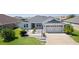 Inviting single-Gathering home with a manicured lawn, charming landscaping, and a two-car garage at 1589 Armstrong Ave, The Villages, FL 32163