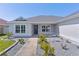 Charming home featuring a well-manicured lawn, beautiful landscaping and a welcoming entrance at 1589 Armstrong Ave, The Villages, FL 32163