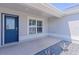 Home exterior featuring a front door with decorative glass, shuttered windows and rock landscaping at 1589 Armstrong Ave, The Villages, FL 32163