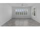 Open-plan living area with tile flooring, enhanced by a ceiling fan and shuttered window at 1589 Armstrong Ave, The Villages, FL 32163