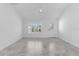 An empty living room featuring tile floors, natural light from the window and a ceiling fan at 1589 Armstrong Ave, The Villages, FL 32163
