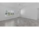 Bright living room featuring neutral walls and floors, a front door with decorative glass and a ceiling fan at 1589 Armstrong Ave, The Villages, FL 32163