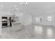 Bright, open floor plan showcasing a kitchen with stainless appliances and adjacent living area with tile flooring at 1589 Armstrong Ave, The Villages, FL 32163