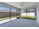 Enclosed patio with black screens that provide a view of the well maintained yard at 1589 Armstrong Ave, The Villages, FL 32163