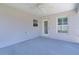 Enclosed patio with ceiling fan and two windows providing backyard views and natural light at 1589 Armstrong Ave, The Villages, FL 32163