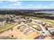Expansive aerial view of a resort community with golf course, villas, and waterfront access at 16028 Trivoli Cir, Montverde, FL 34756