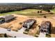 Aerial view of a two-story home with a tile roof next to a golf course and wooded area at 16028 Trivoli Cir, Montverde, FL 34756