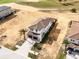 Aerial view of a two-story home and neighboring properties with a brick driveway and tile roof at 16028 Trivoli Cir, Montverde, FL 34756