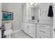 Well-lit bathroom with white cabinets, modern fixtures, and stylish decor at 16028 Trivoli Cir, Montverde, FL 34756