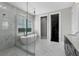 Modern bathroom with a glass walk-in shower, soaking tub and elegant finishes create a spa-like retreat at 16028 Trivoli Cir, Montverde, FL 34756