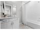 This bathroom features a vanity with mirror and tub with shower at 16028 Trivoli Cir, Montverde, FL 34756