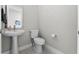 Half-bath featuring white fixtures, pedestal sink, tiled floors, and neutral paint at 16028 Trivoli Cir, Montverde, FL 34756