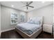 This bedroom features wood floors, fan, and windows with white shutters at 16028 Trivoli Cir, Montverde, FL 34756