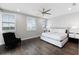 This bedroom features hardwood floors, fan, and windows with white shutters at 16028 Trivoli Cir, Montverde, FL 34756
