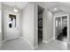 Bright foyer featuring neutral wall colors, tile flooring, and an eye-catching gold light fixture at 16028 Trivoli Cir, Montverde, FL 34756