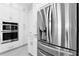 Close-up of kitchen appliances, including a stainless steel refrigerator and built-in oven at 16028 Trivoli Cir, Montverde, FL 34756