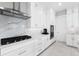 Well-appointed kitchen features stainless steel appliances, white cabinetry, and marble backsplash at 16028 Trivoli Cir, Montverde, FL 34756