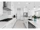 Bright kitchen with stainless steel appliances, white marble countertops, and a center island at 16028 Trivoli Cir, Montverde, FL 34756