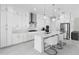 Modern kitchen featuring a center island, stainless steel appliances, and ample storage space in white cabinets at 16028 Trivoli Cir, Montverde, FL 34756
