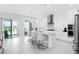 Bright, modern kitchen features an island with bar seating, white cabinets, and stainless steel appliances at 16028 Trivoli Cir, Montverde, FL 34756